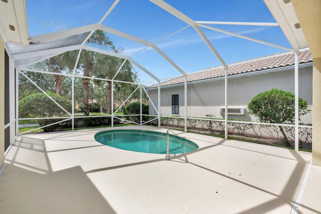 view of swimming pool with a lanai and a patio