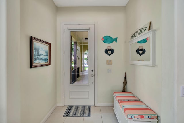 doorway to outside with light tile patterned floors