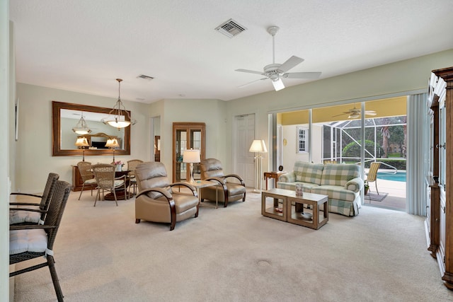 living room with a textured ceiling and light carpet