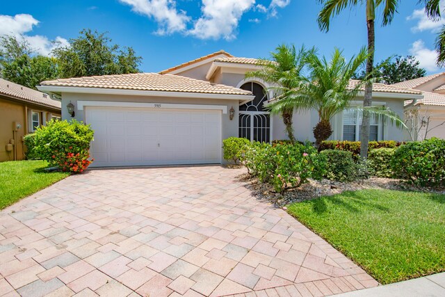 mediterranean / spanish home featuring a garage