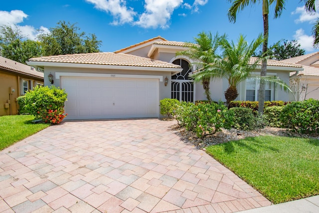 mediterranean / spanish house featuring a garage