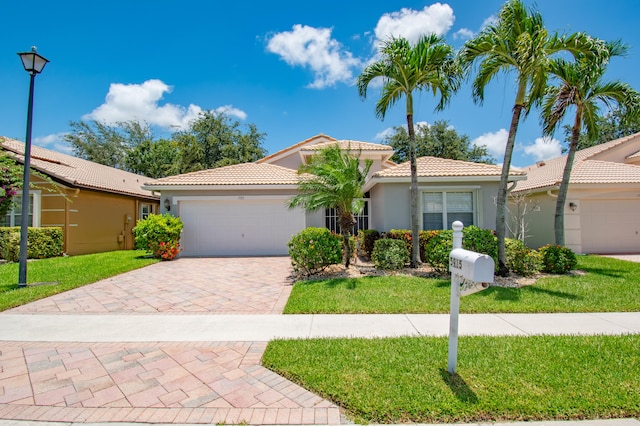 view of front of home featuring a garage and a front lawn