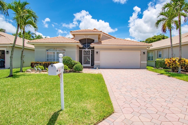 mediterranean / spanish house with a front yard and a garage