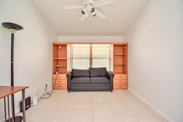 sitting room featuring ceiling fan and light tile floors