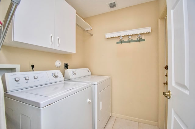 clothes washing area with separate washer and dryer, cabinets, washer hookup, hookup for an electric dryer, and light tile floors