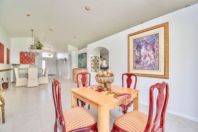 tiled dining room with vaulted ceiling