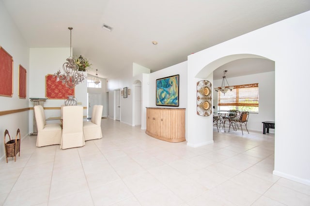 tiled dining room with vaulted ceiling