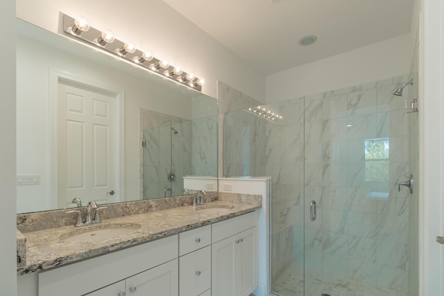 bathroom featuring vanity and an enclosed shower