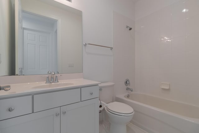 full bathroom with vanity, tiled shower / bath combo, and toilet