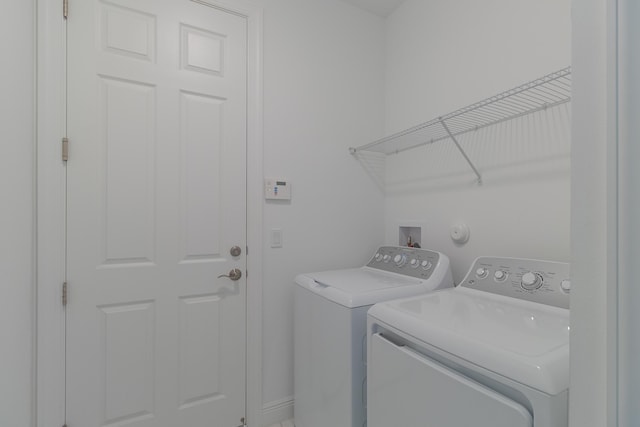 washroom with independent washer and dryer