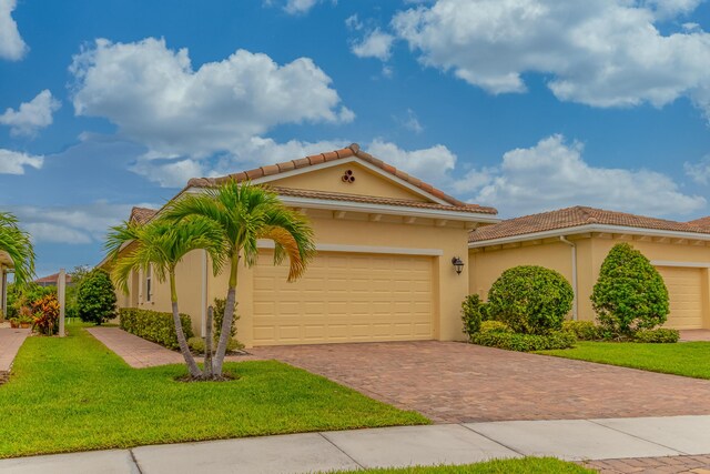 mediterranean / spanish-style house with a garage