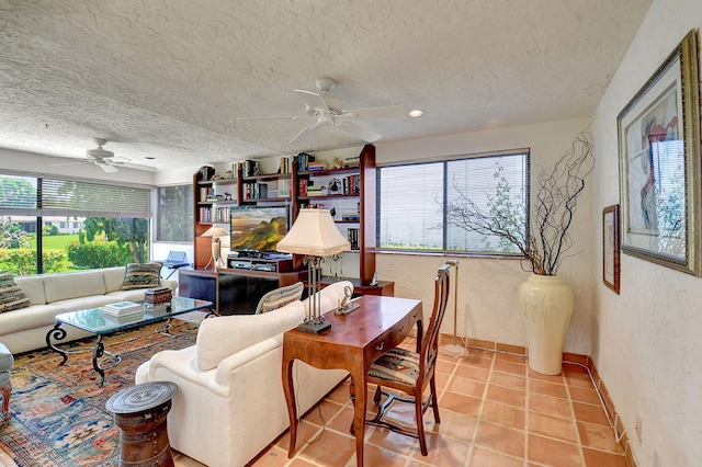 tiled living room with a textured ceiling and ceiling fan