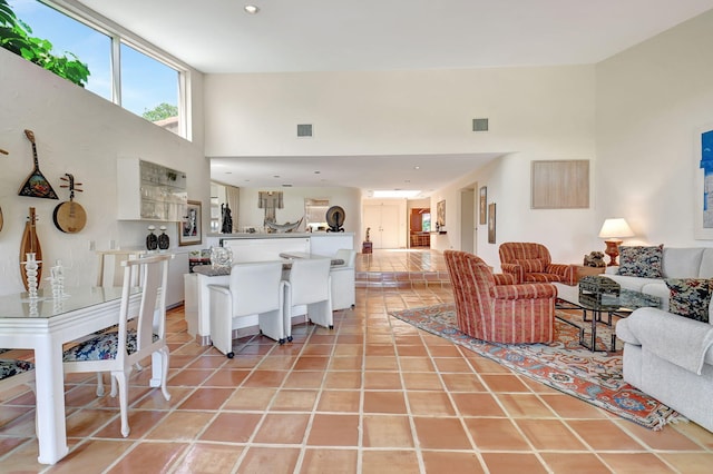 living room featuring a high ceiling and light tile patterned flooring