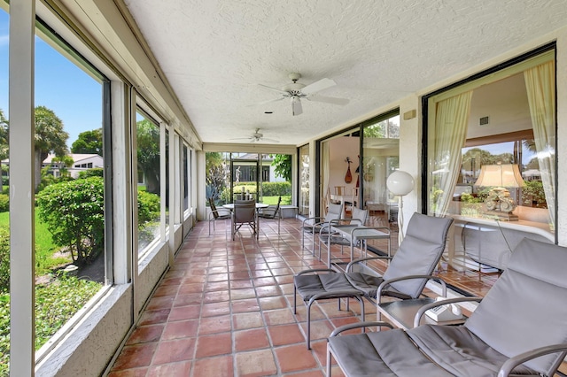 sunroom featuring ceiling fan