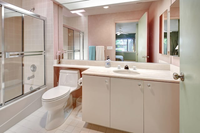 full bathroom featuring vanity, shower / bath combination with glass door, tile patterned floors, ceiling fan, and toilet