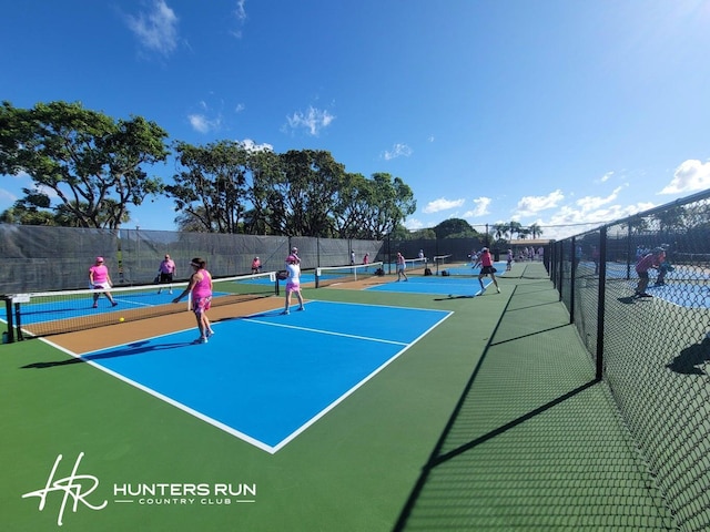 view of tennis court featuring basketball hoop