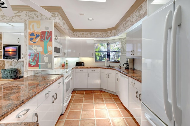 kitchen with light stone counters, white appliances, sink, light tile patterned floors, and white cabinets