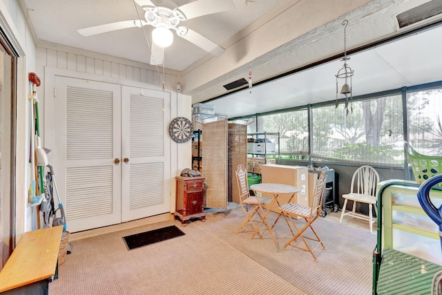 sunroom featuring a wealth of natural light and ceiling fan