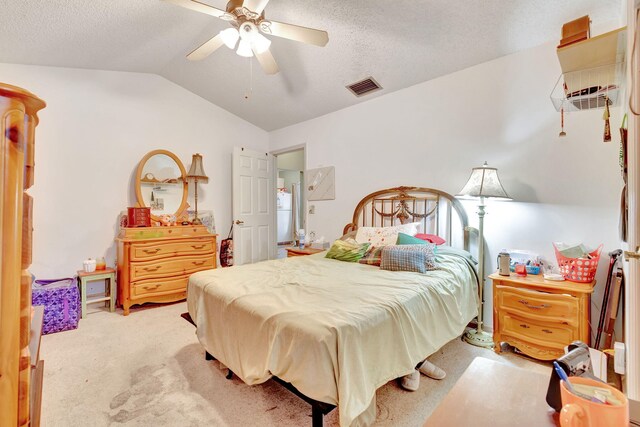 carpeted bedroom with a textured ceiling, ceiling fan, and lofted ceiling