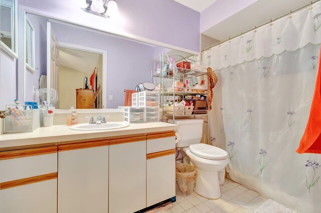 bathroom with vanity, toilet, and tile patterned flooring