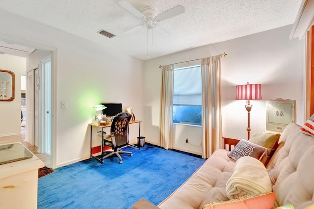 office with carpet floors, a textured ceiling, and ceiling fan