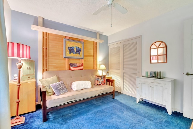 living area with dark colored carpet, a textured ceiling, and ceiling fan