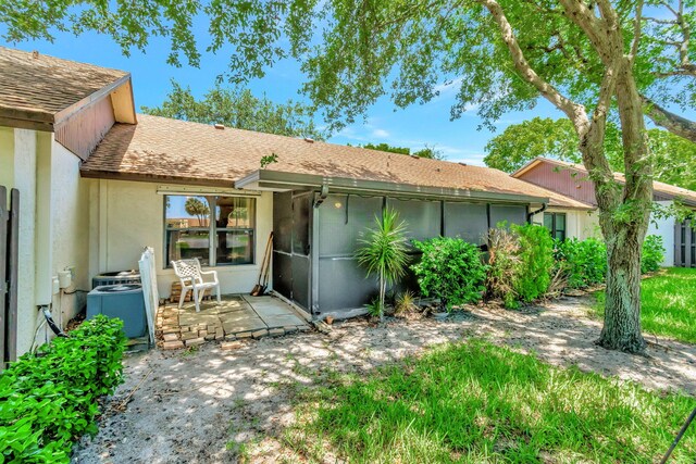 rear view of property featuring central AC and a patio area