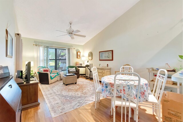 interior space with light wood-type flooring, ceiling fan, and vaulted ceiling