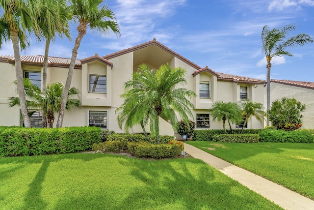 mediterranean / spanish-style home featuring a front lawn