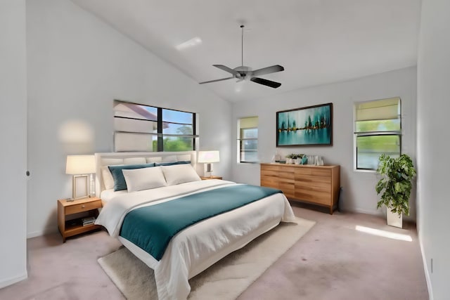 bedroom featuring a ceiling fan, lofted ceiling, light colored carpet, and baseboards
