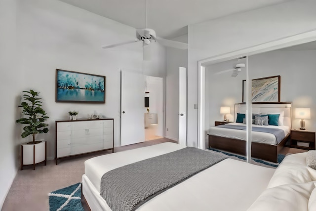 bedroom featuring carpet flooring, ensuite bathroom, and ceiling fan