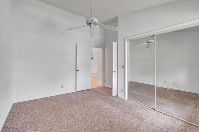 unfurnished bedroom featuring a ceiling fan, carpet flooring, baseboards, and a closet