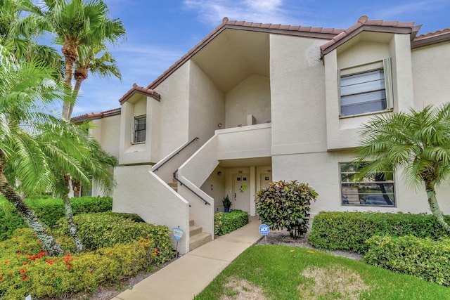 view of front of property with a tiled roof and stucco siding