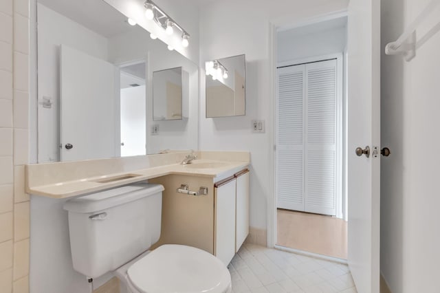 bathroom featuring toilet and vanity