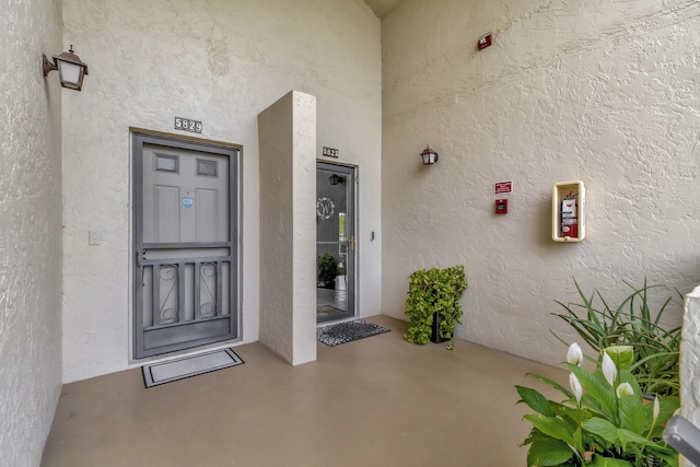 entrance to property featuring stucco siding