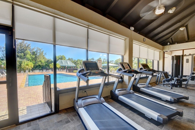 gym with ceiling fan and vaulted ceiling