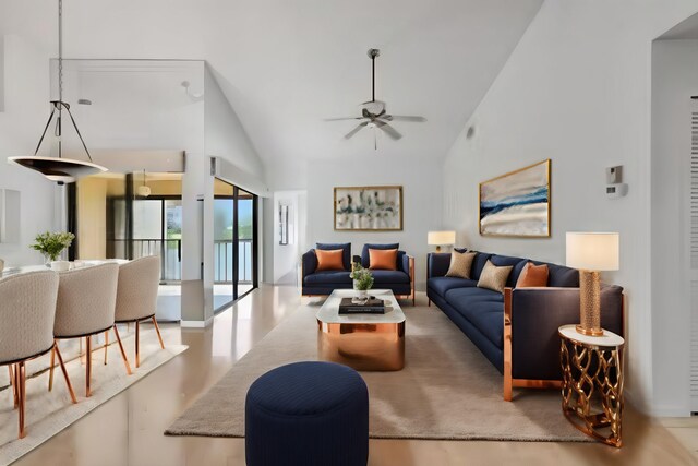 living room with high vaulted ceiling and ceiling fan