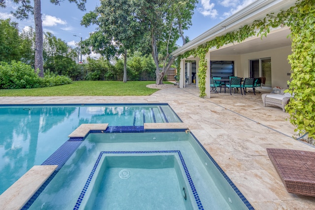 view of swimming pool featuring a patio area, a lawn, and an in ground hot tub