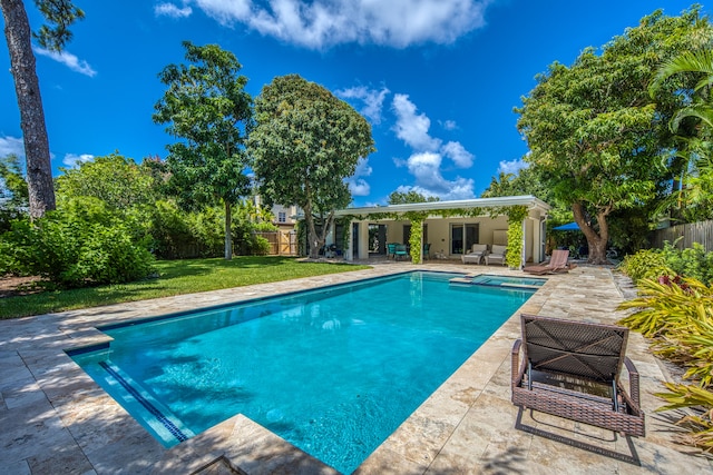 view of swimming pool with a patio and a lawn