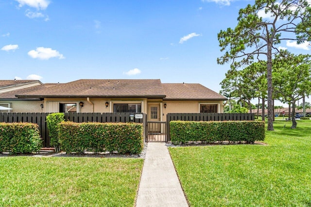 ranch-style home featuring a front yard