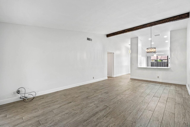 unfurnished living room with vaulted ceiling with beams and hardwood / wood-style flooring