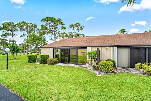 rear view of property featuring a yard