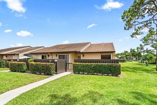 ranch-style house featuring a front lawn