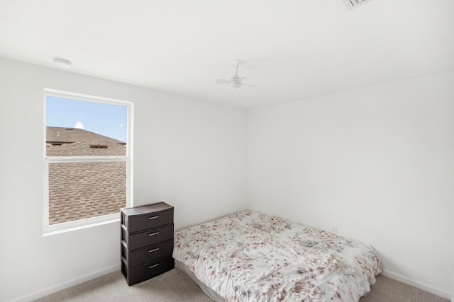 bedroom with ceiling fan and light carpet