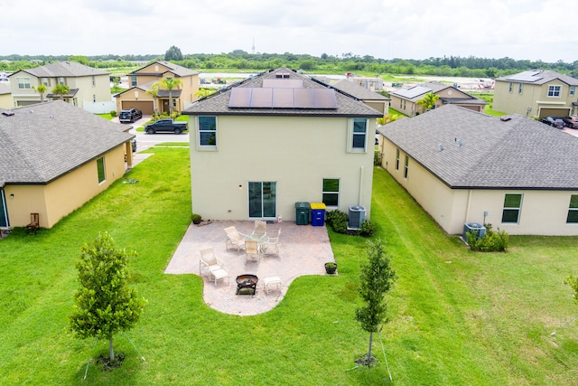 rear view of property featuring a yard, a patio, and central air condition unit