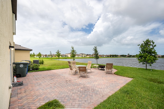 view of patio with a water view and central air condition unit