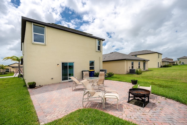 back of house with a yard, a patio area, and central air condition unit