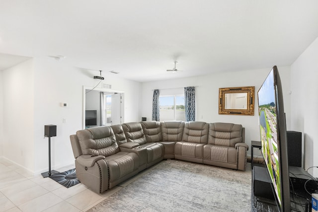 living room featuring ceiling fan and light tile patterned floors