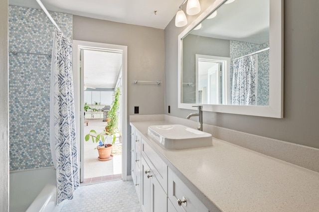 bathroom with shower / tub combo, vanity, and tile patterned floors