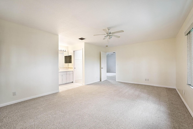 unfurnished room with ceiling fan and light colored carpet